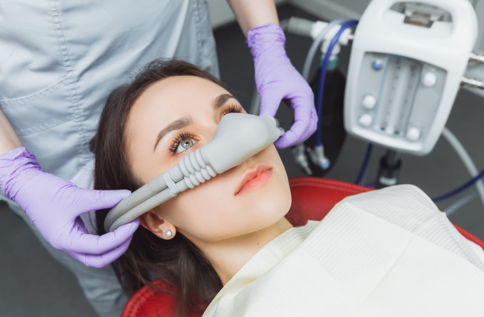 Patient relaxing in the dental chair with a nasal sedation mask