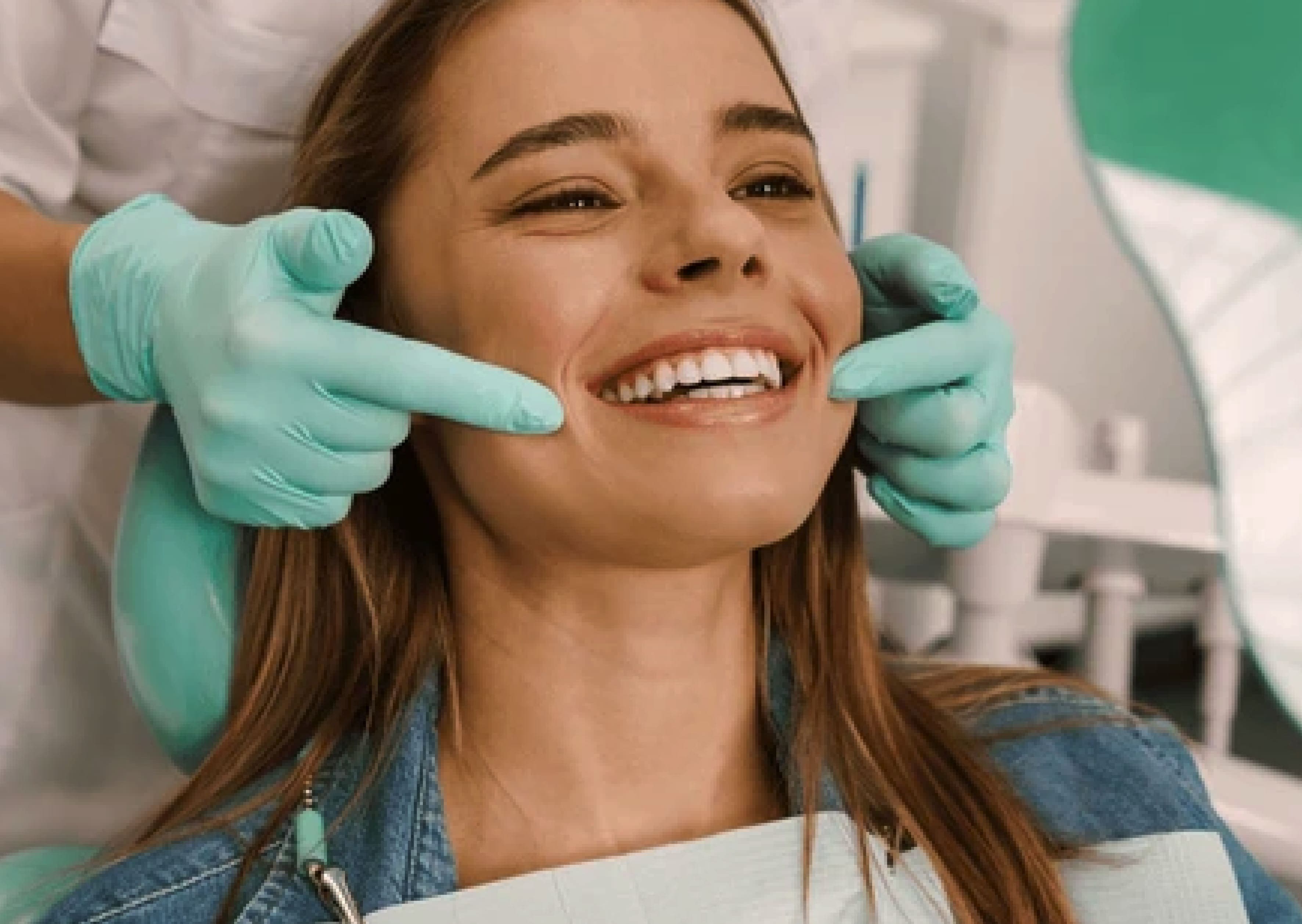 Dentist examining a smiling patient's teeth