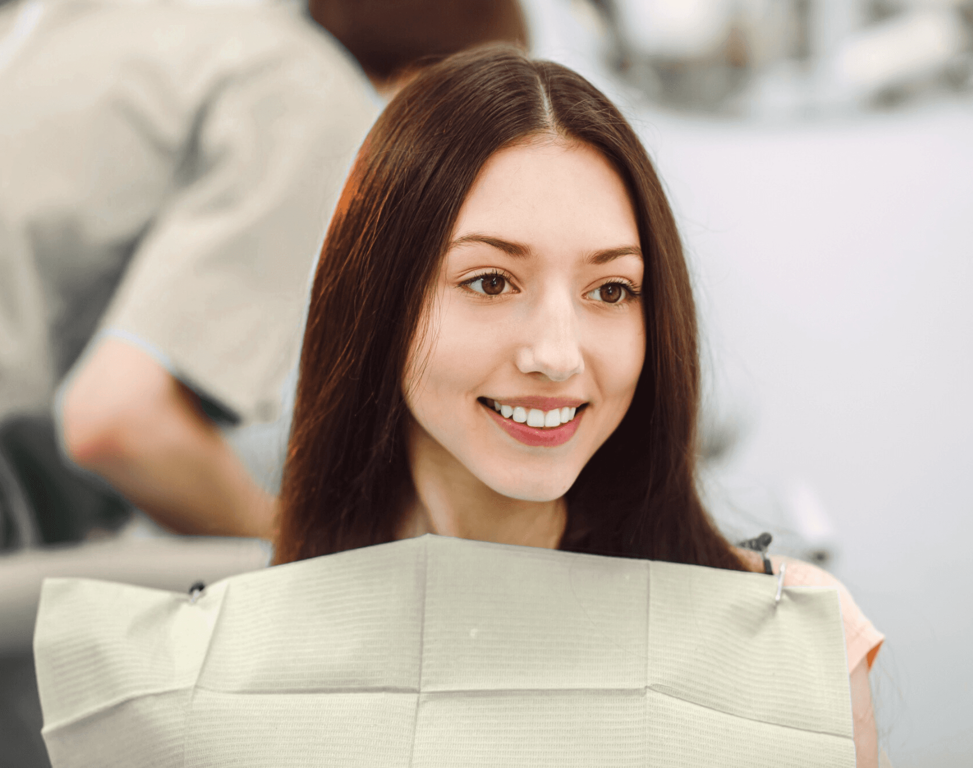 Smiling young woman in the dental chair